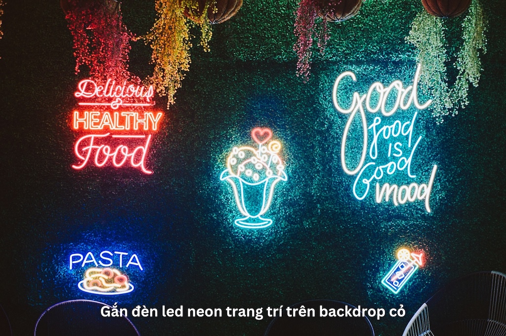 Gắn đèn LED neon trang trí trên backdrop cỏ